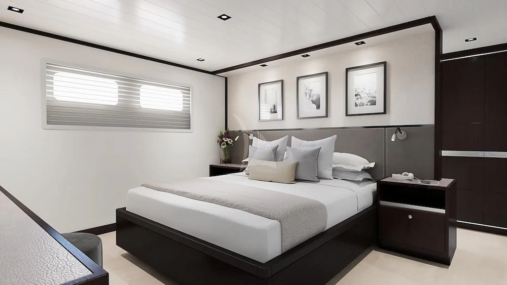 a bedroom with a bed and a desk aboard EMERALD Yacht for Charter