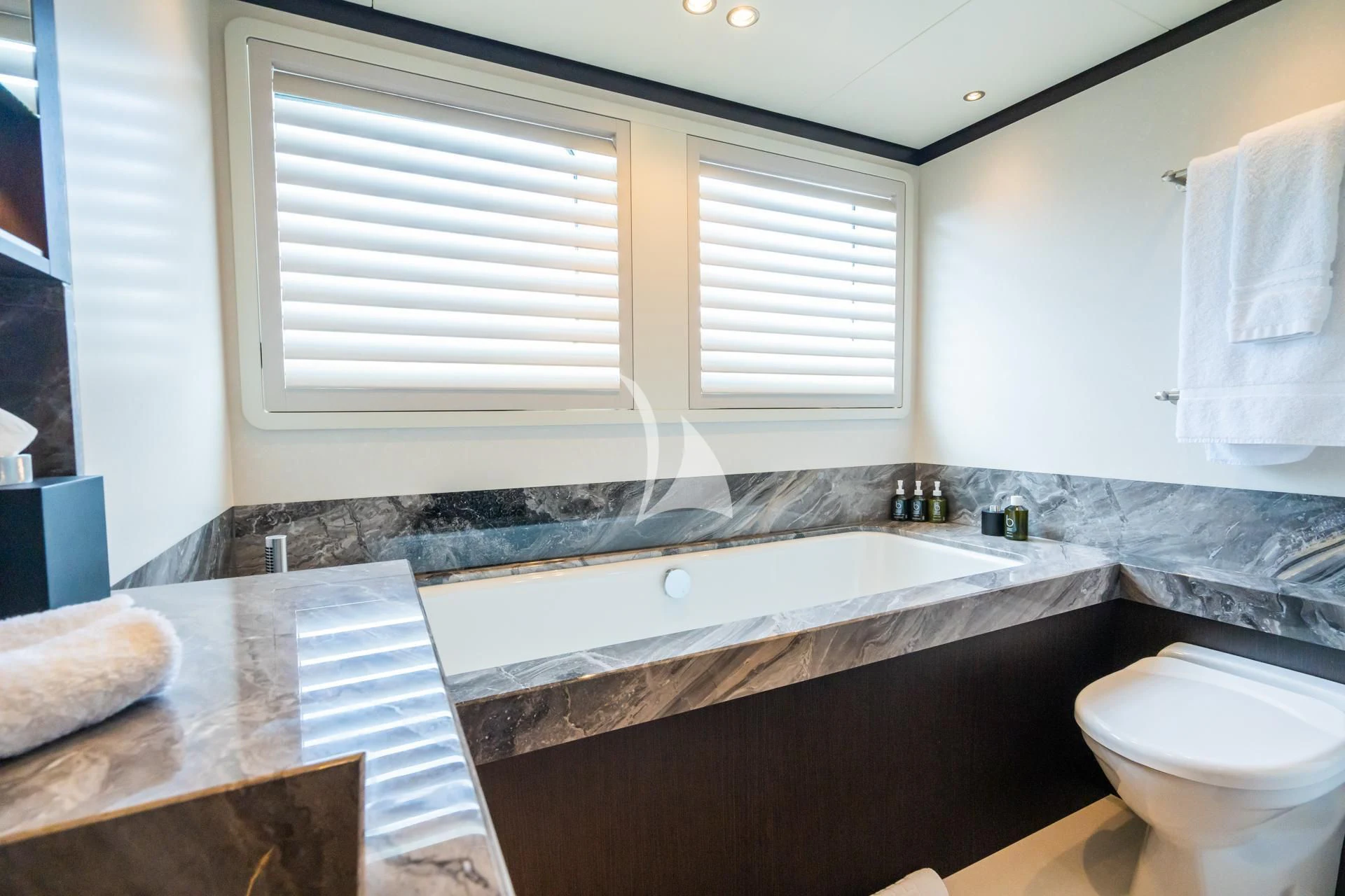a bathroom with a tub sink and toilet aboard EMERALD Yacht for Charter