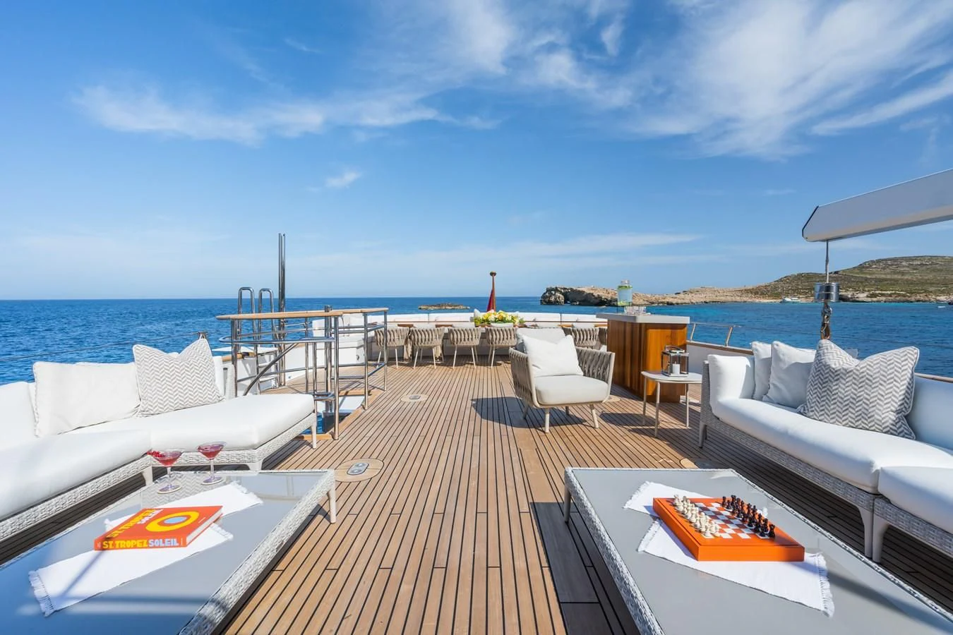 a deck with a table and chairs on it aboard EMERALD Yacht for Charter