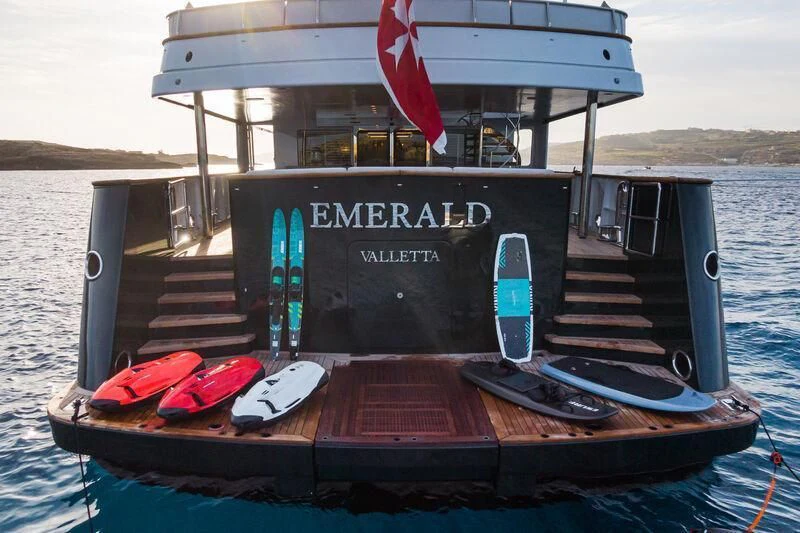 a boat with a flag on the front aboard EMERALD Yacht for Charter