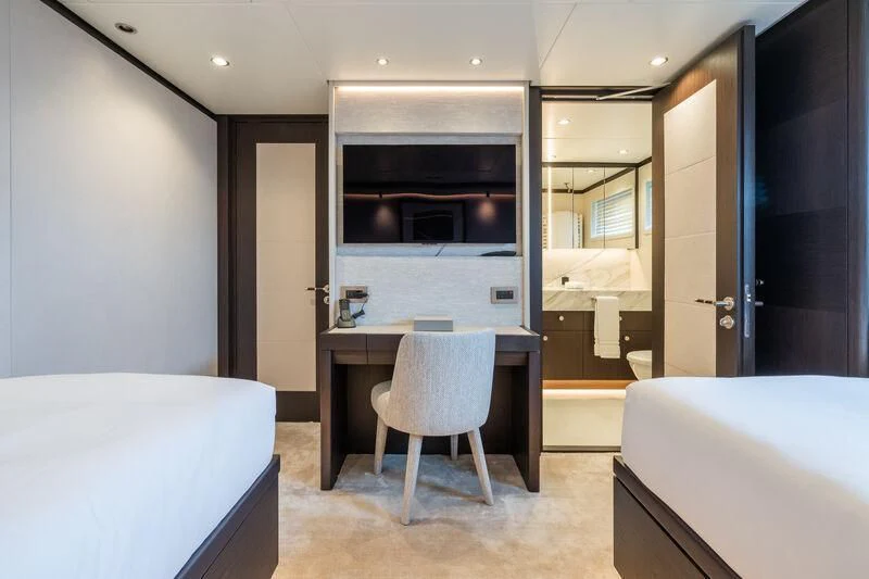 a room with a bed and a chair aboard EMERALD Yacht for Charter