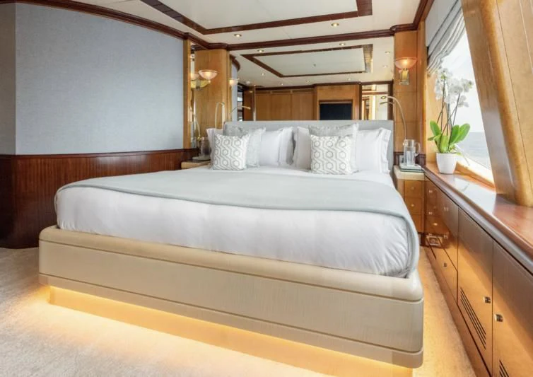 a bed with white sheets aboard JAGUAR Yacht for Charter