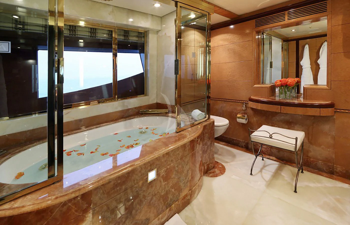 a bathroom with a tub and a bench aboard JAGUAR Yacht for Charter