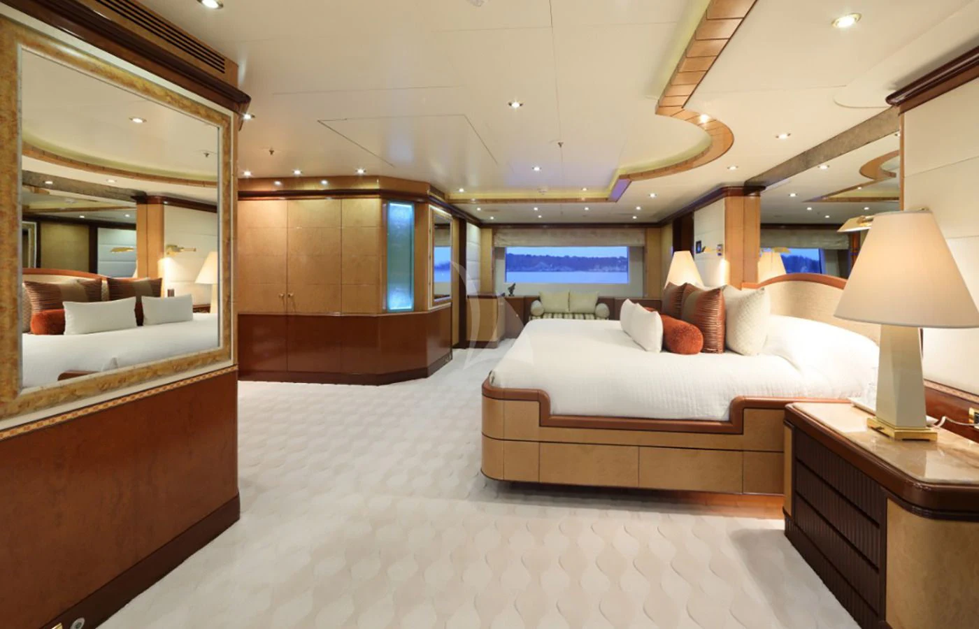 a hotel room with a bed and a desk aboard JAGUAR Yacht for Charter