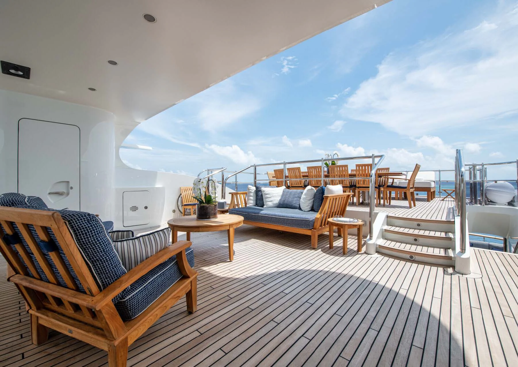 a large white and blue lounge area with a large white and wood deck aboard JAGUAR Yacht for Charter