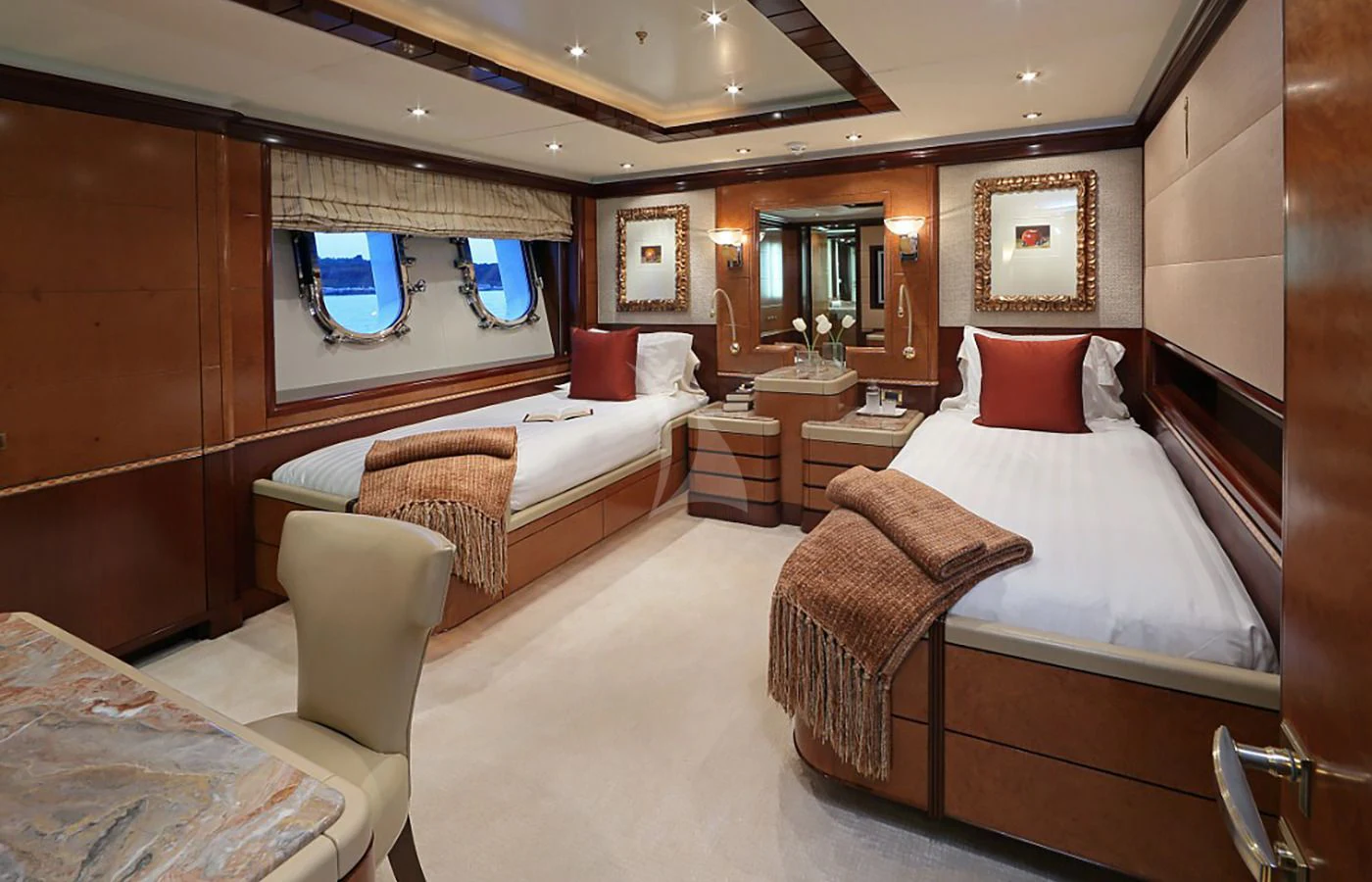 a room with a bed and a desk aboard JAGUAR Yacht for Charter