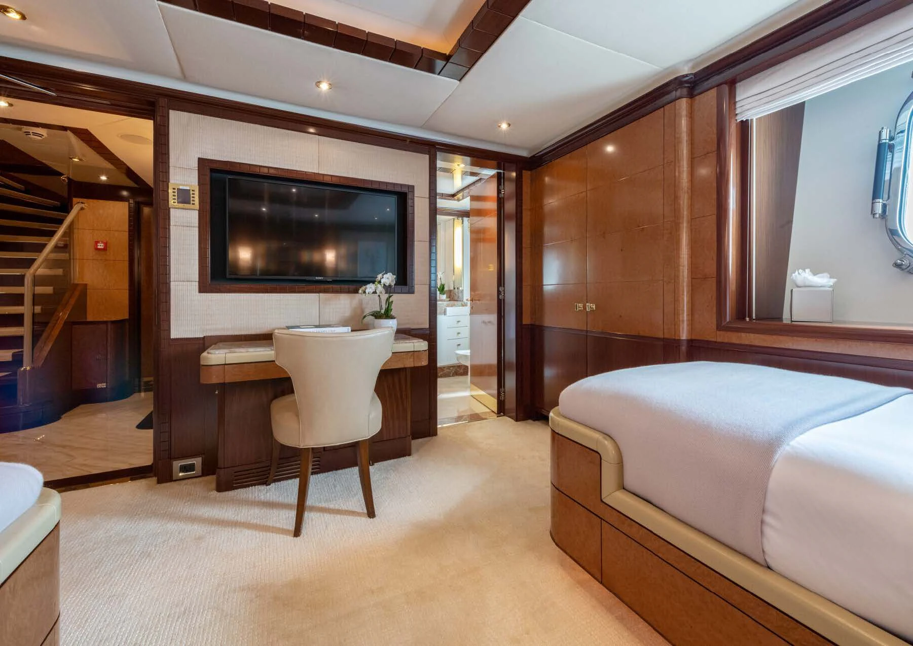 a hotel room with a bed and a tv aboard JAGUAR Yacht for Charter