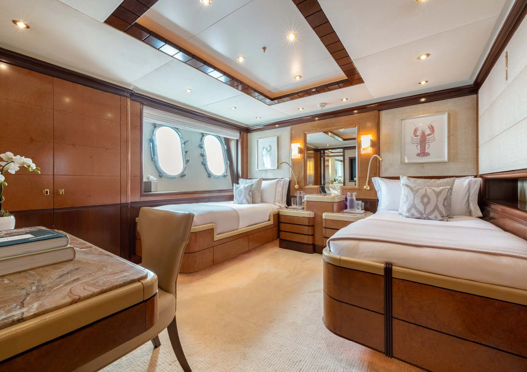 a room with a bed and a table aboard JAGUAR Yacht for Charter