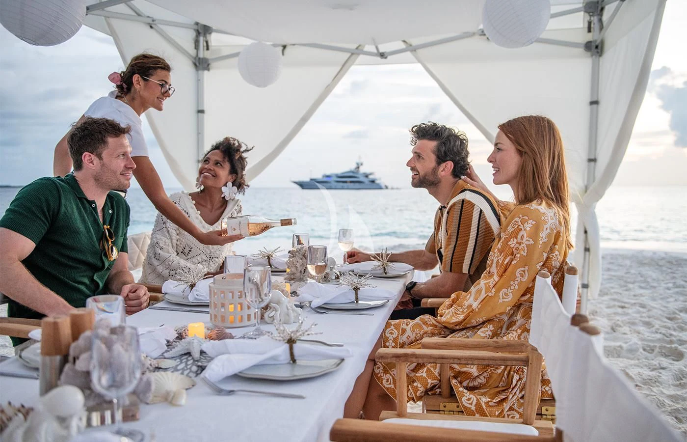 a group of people sitting at a table aboard JAGUAR Yacht for Charter