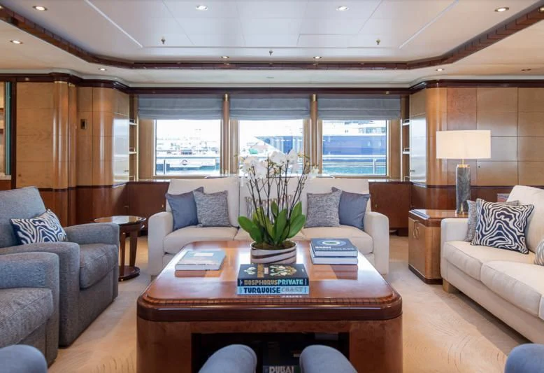 a living room with a table and couches aboard JAGUAR Yacht for Charter