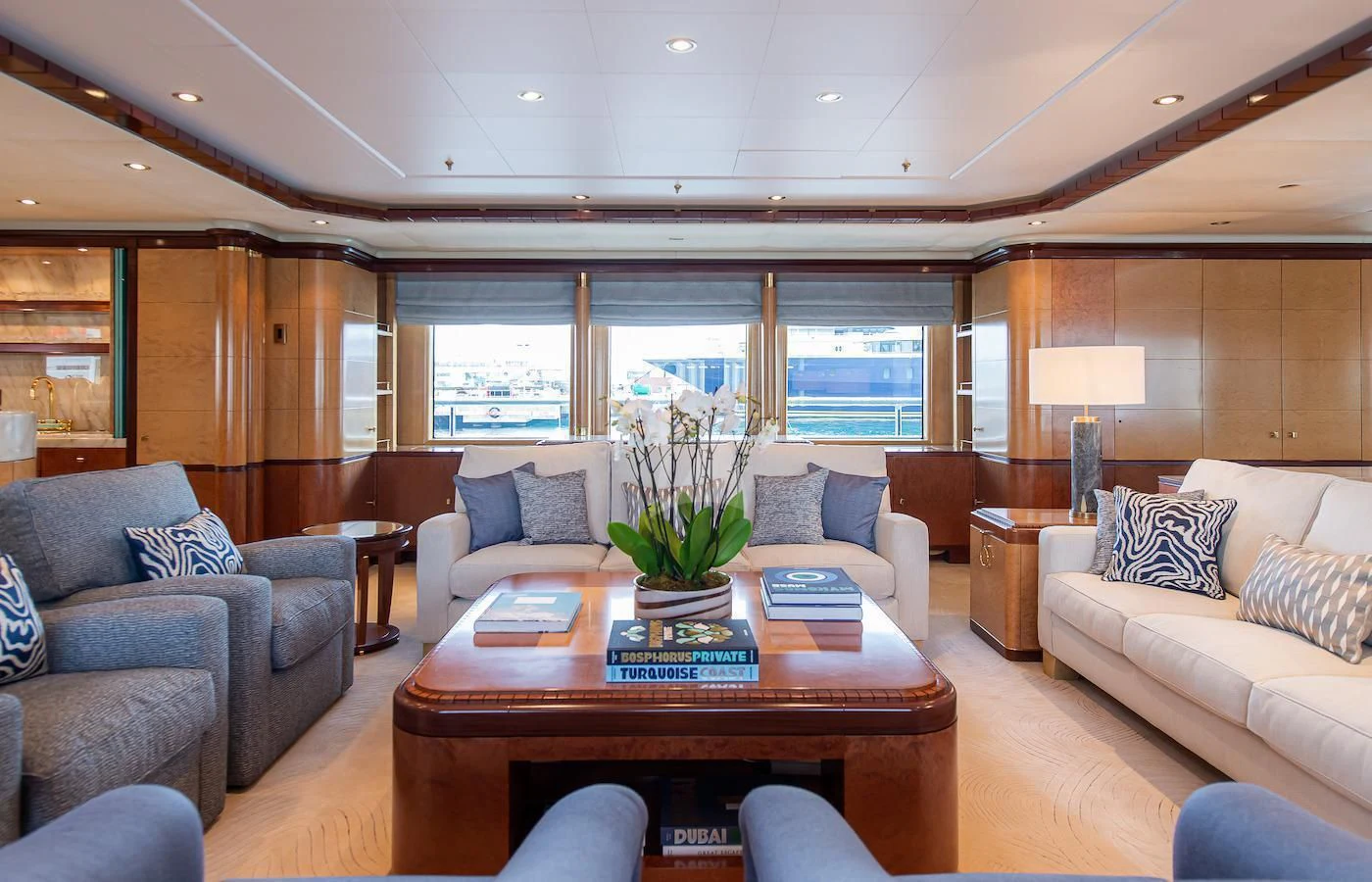 a living room with a table and couches aboard JAGUAR Yacht for Charter