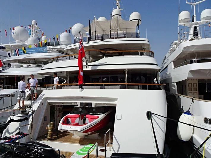 a boat docked with people walking on the deck aboard JAGUAR Yacht for Charter