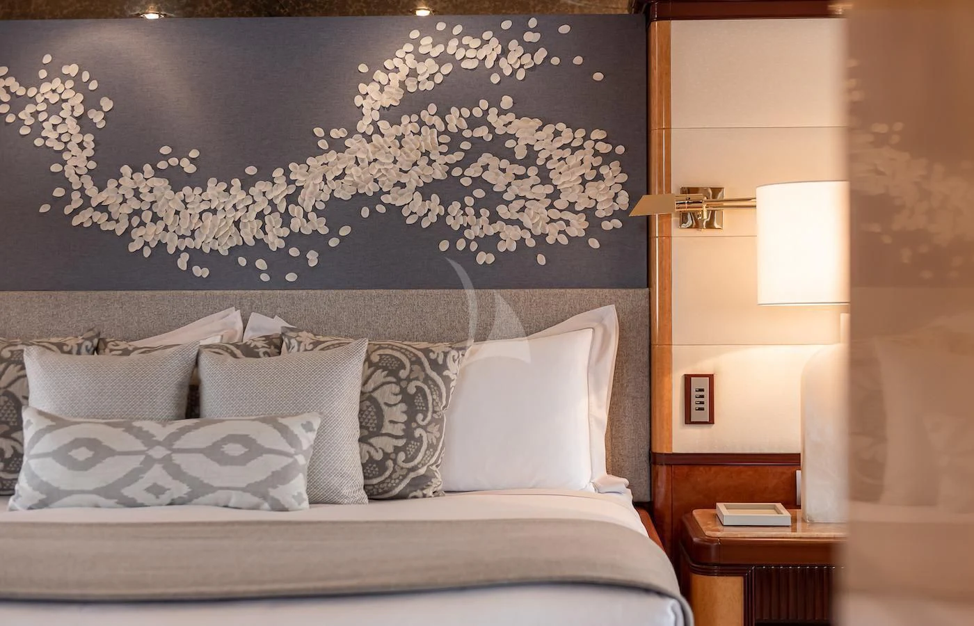 a bed with a blue wall aboard JAGUAR Yacht for Charter