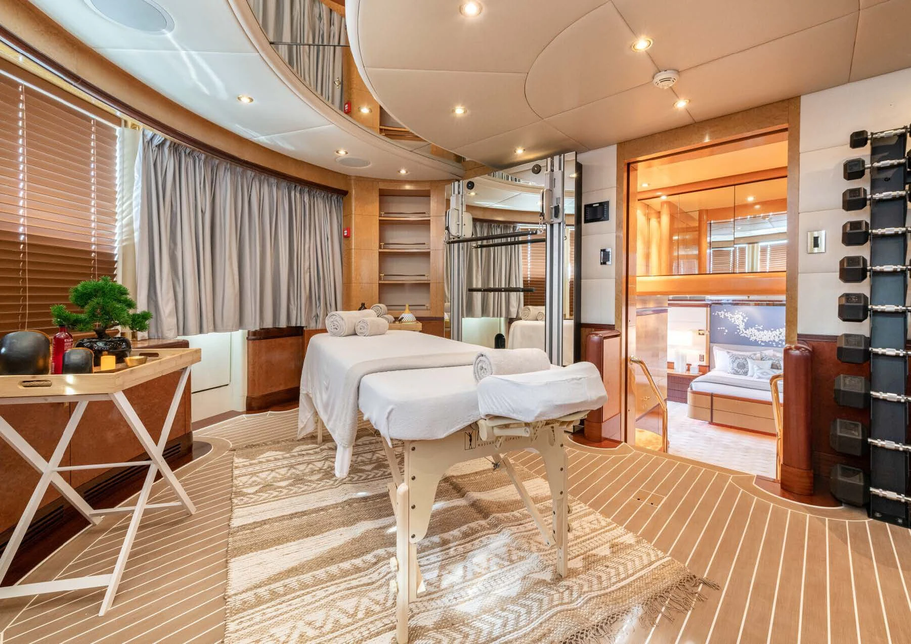 a room with a bed and a table aboard JAGUAR Yacht for Charter
