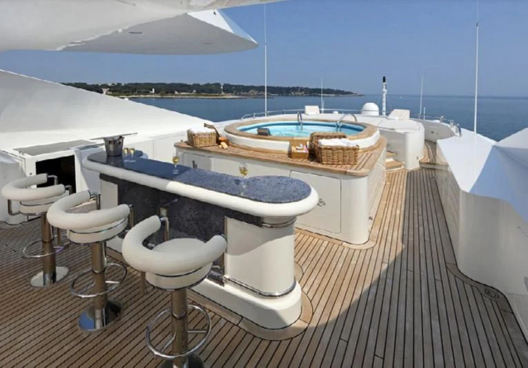 a boat dock with a couple of tables and chairs on it aboard JAGUAR Yacht for Charter