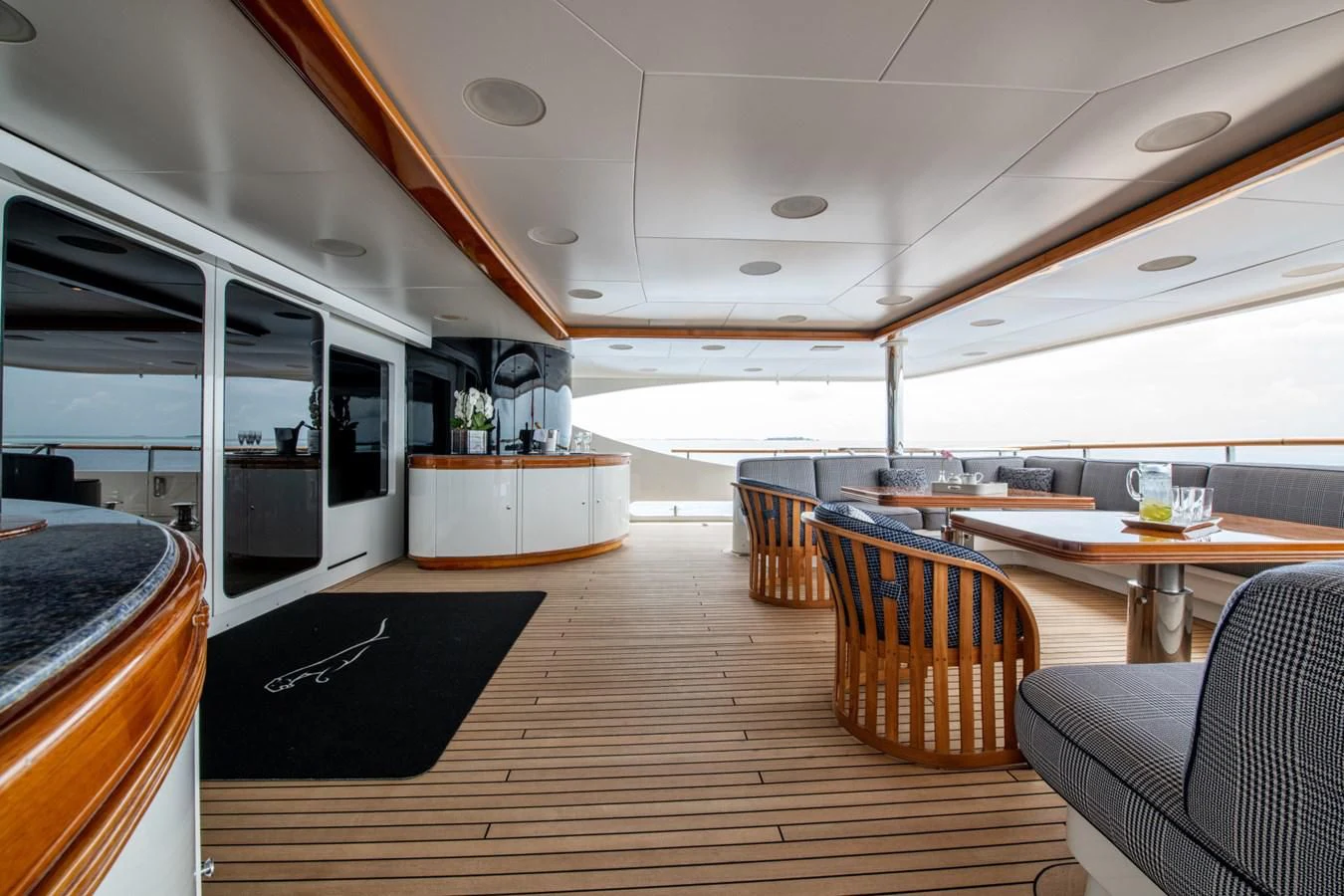a room with a wood floor and a large window with a wood floor aboard JAGUAR Yacht for Charter