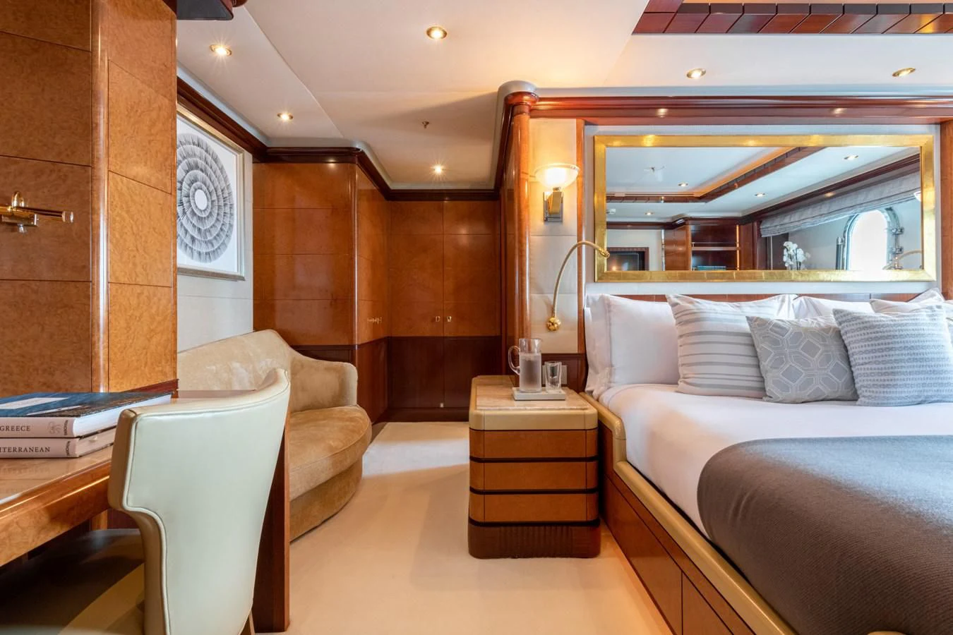 a room with a bed and a chair aboard JAGUAR Yacht for Charter