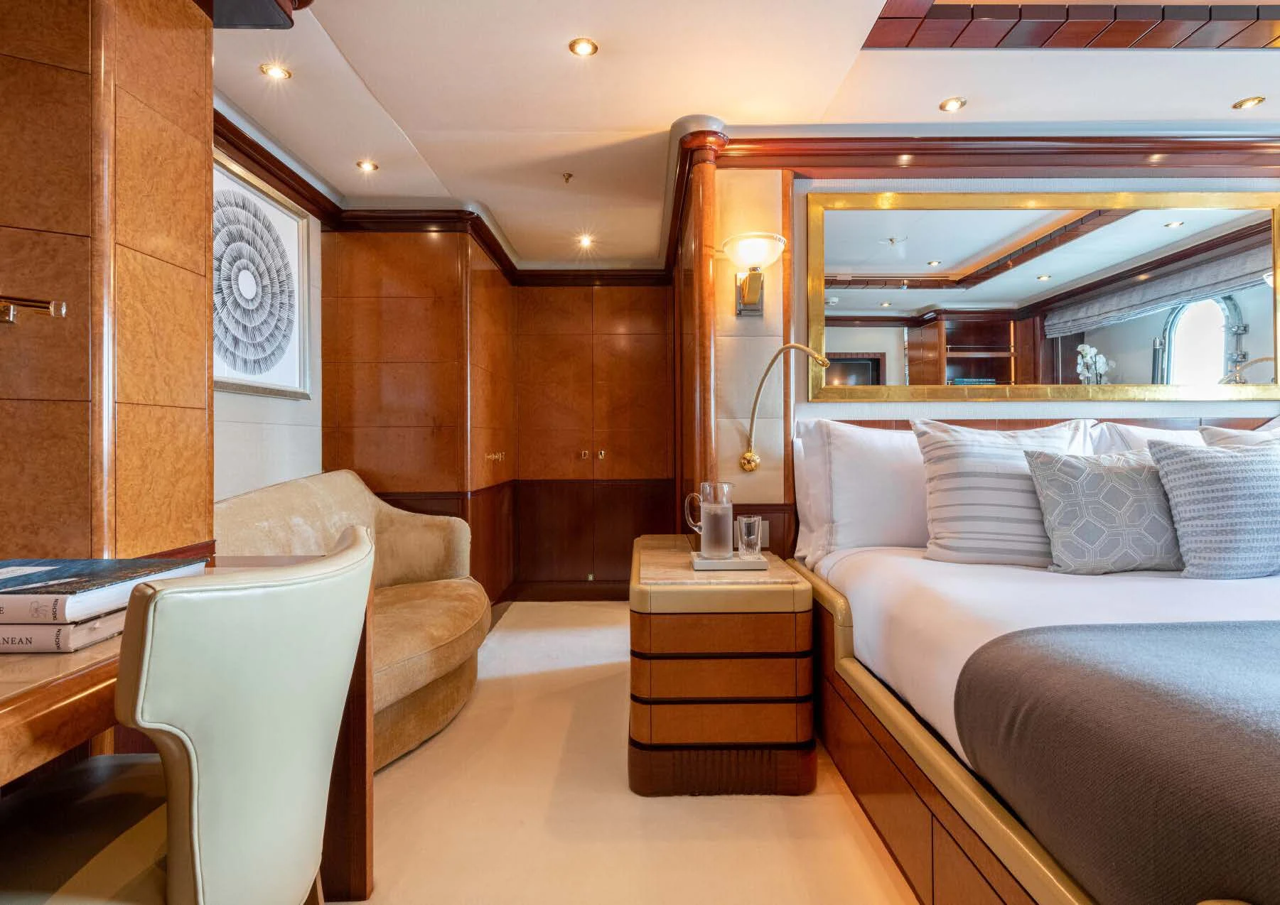 a room with a bed and a chair aboard JAGUAR Yacht for Charter