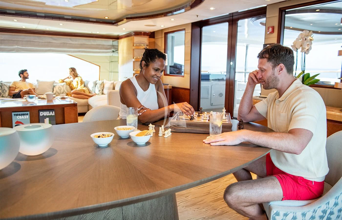 a man and a woman sitting at a table in a restaurant aboard JAGUAR Yacht for Charter
