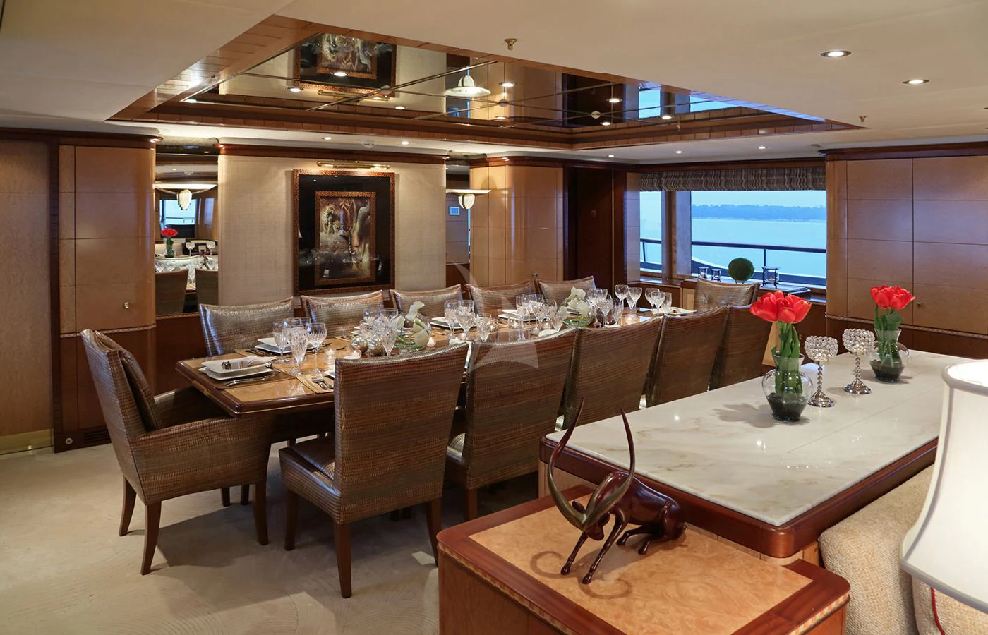 a large room with a table and chairs aboard JAGUAR Yacht for Charter