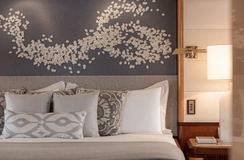 a bed with white pillows aboard JAGUAR Yacht for Charter