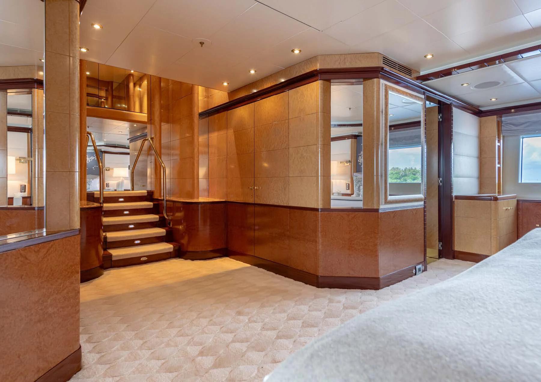 a large room with a bed and a staircase aboard JAGUAR Yacht for Charter