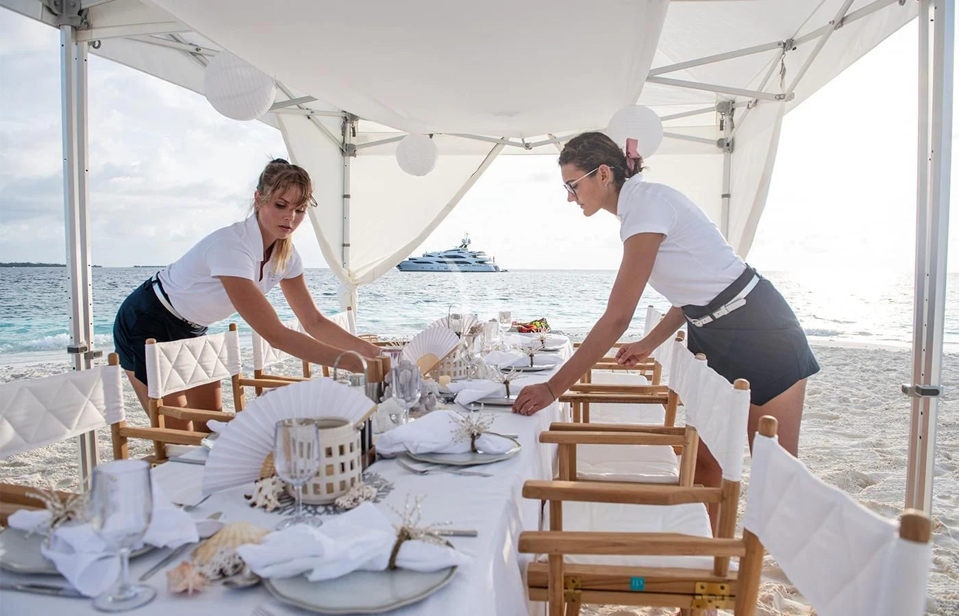 a couple of men preparing food on a boat aboard JAGUAR Yacht for Charter
