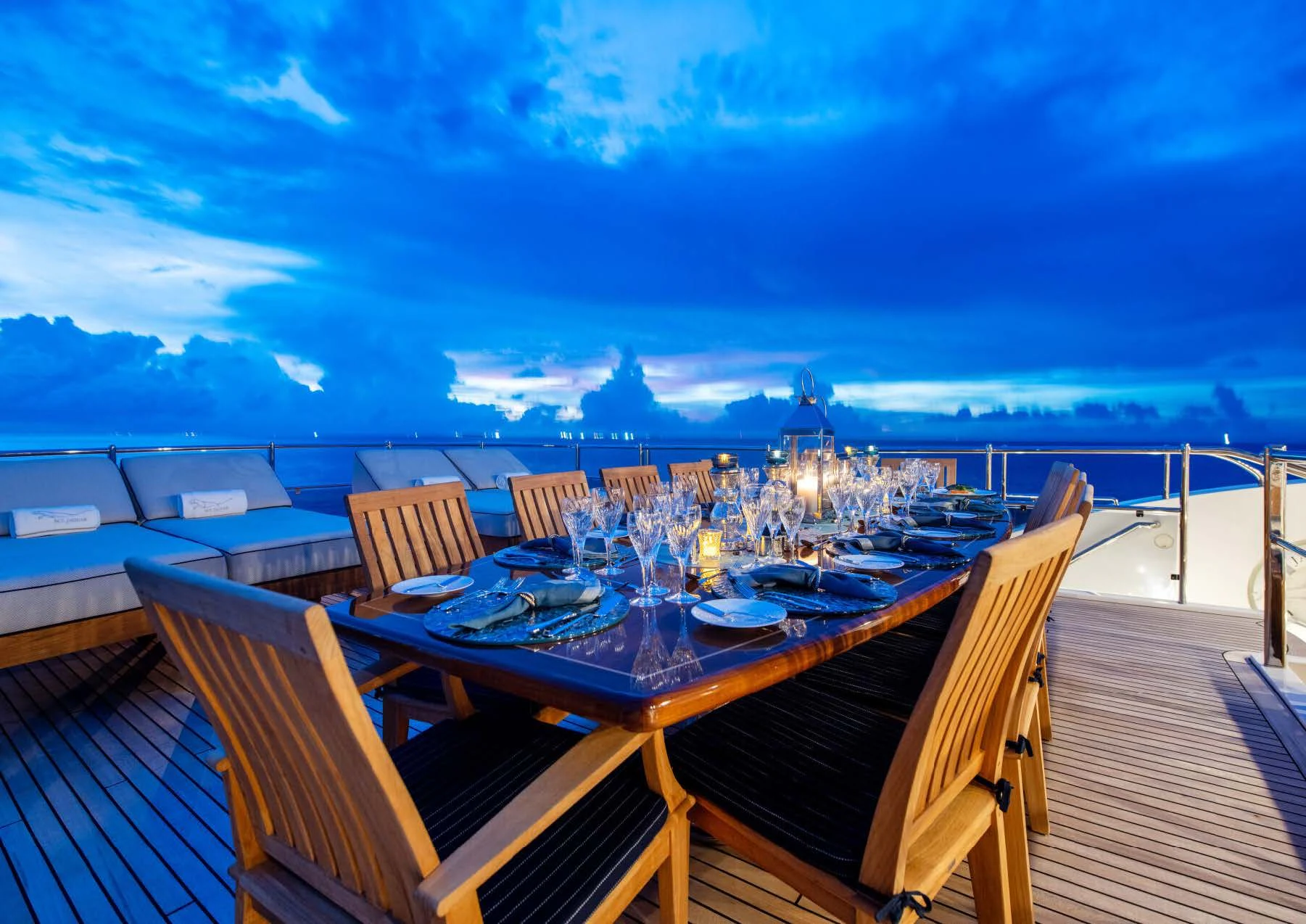 a deck with a table and chairs on it aboard JAGUAR Yacht for Charter