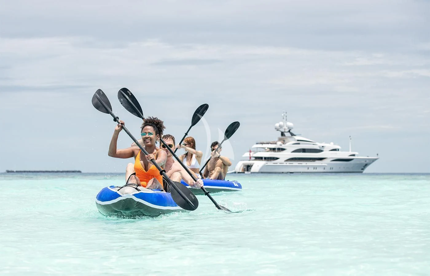 a group of people in a canoe aboard JAGUAR Yacht for Charter