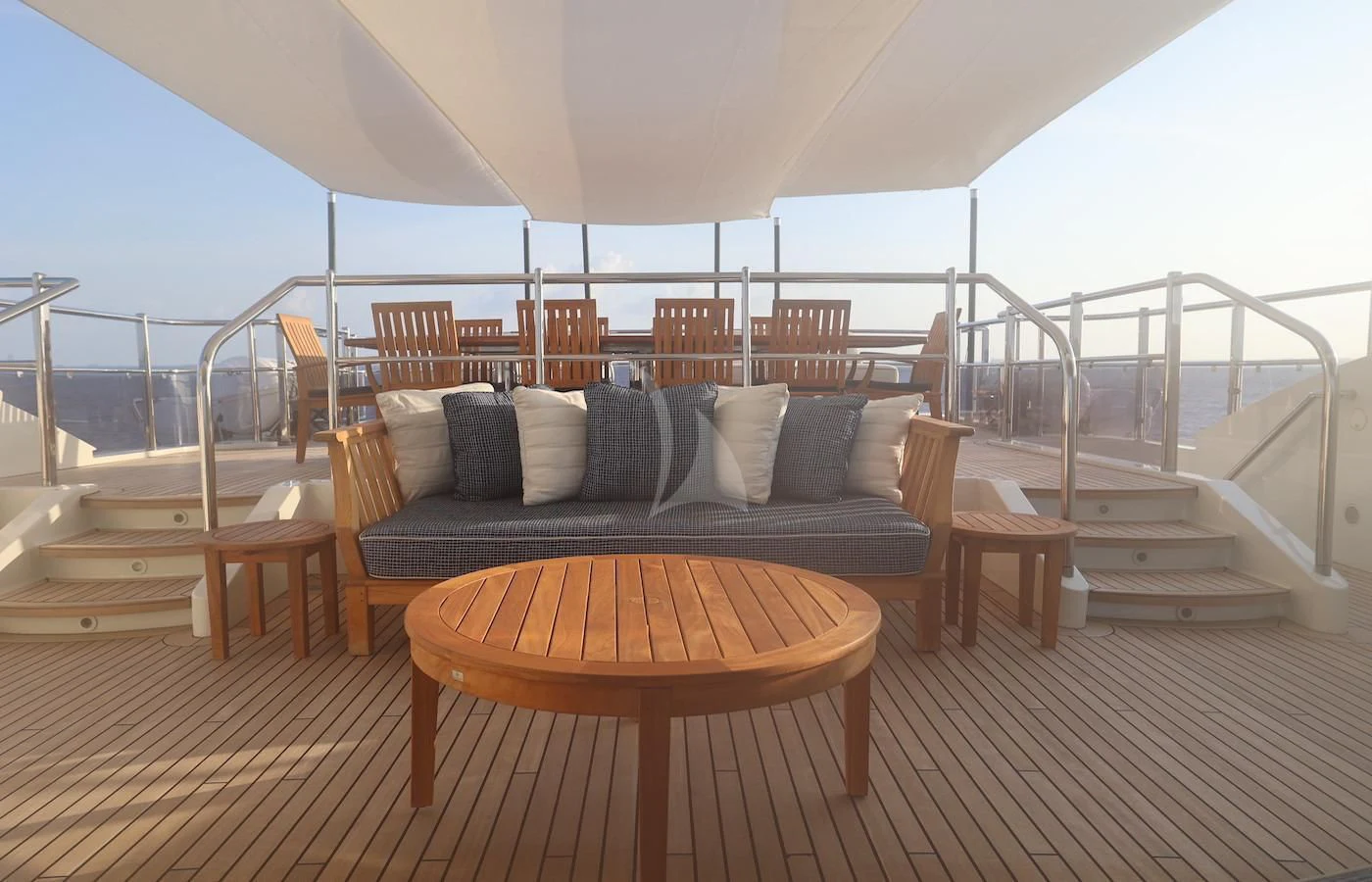 a bed and a table on a deck aboard JAGUAR Yacht for Charter