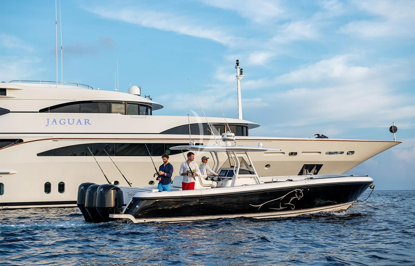 a couple of people standing on a boat in the water aboard JAGUAR Yacht for Charter