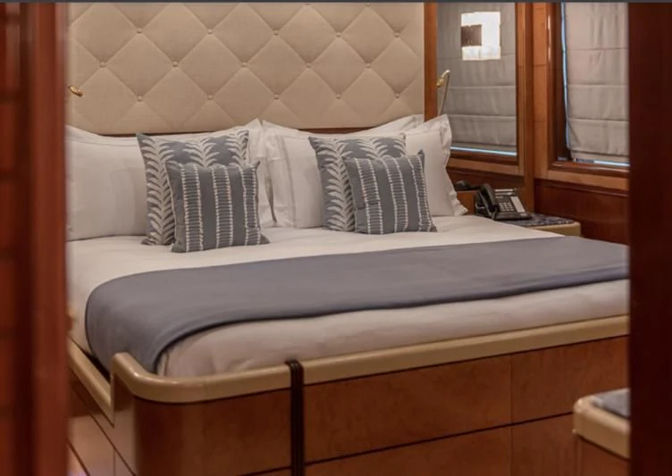 a bed with white sheets aboard JAGUAR Yacht for Charter