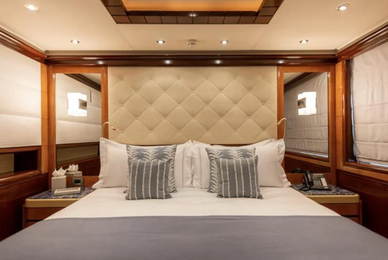 a bed with white sheets and pillows aboard JAGUAR Yacht for Charter