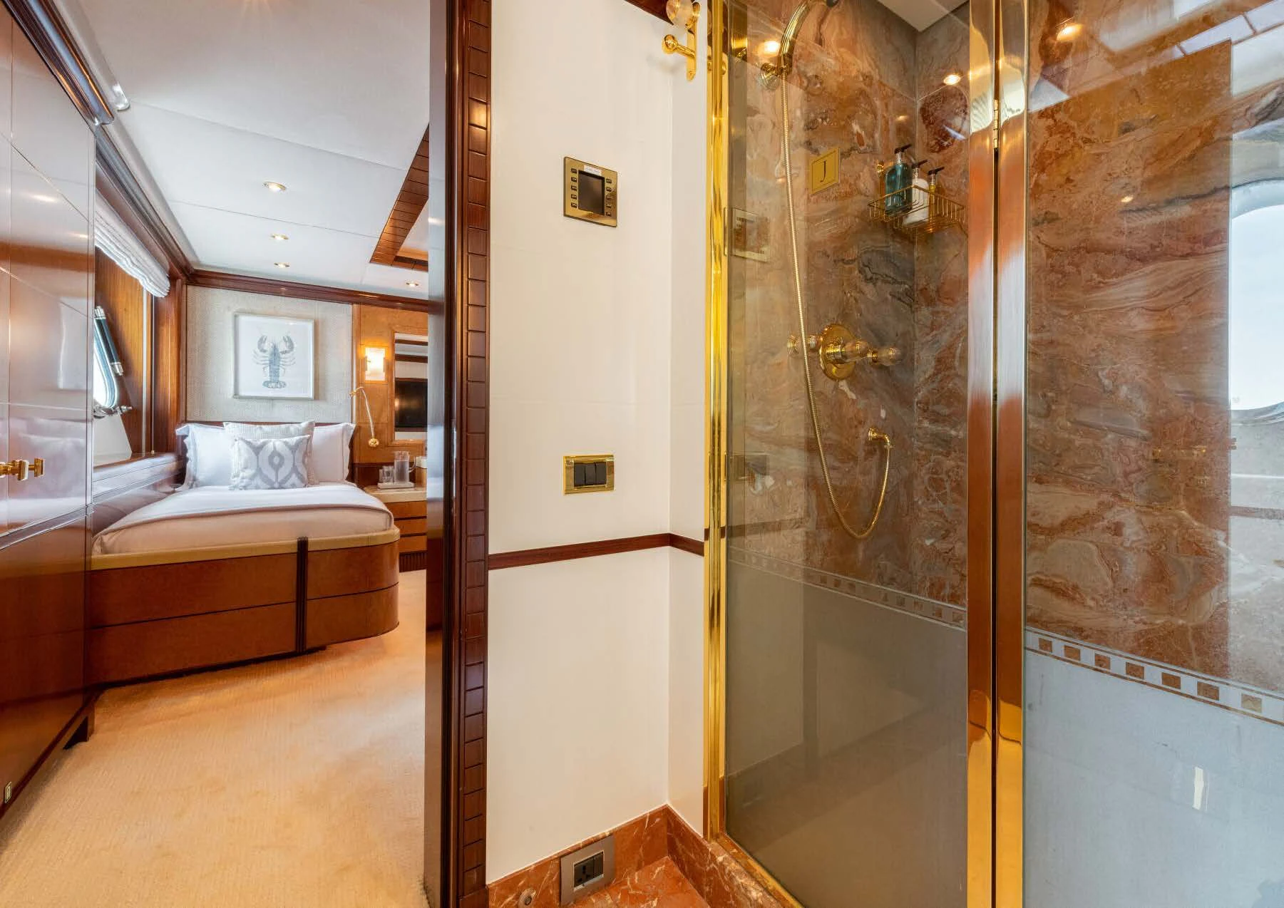 a room with a bed and a mirror aboard JAGUAR Yacht for Charter