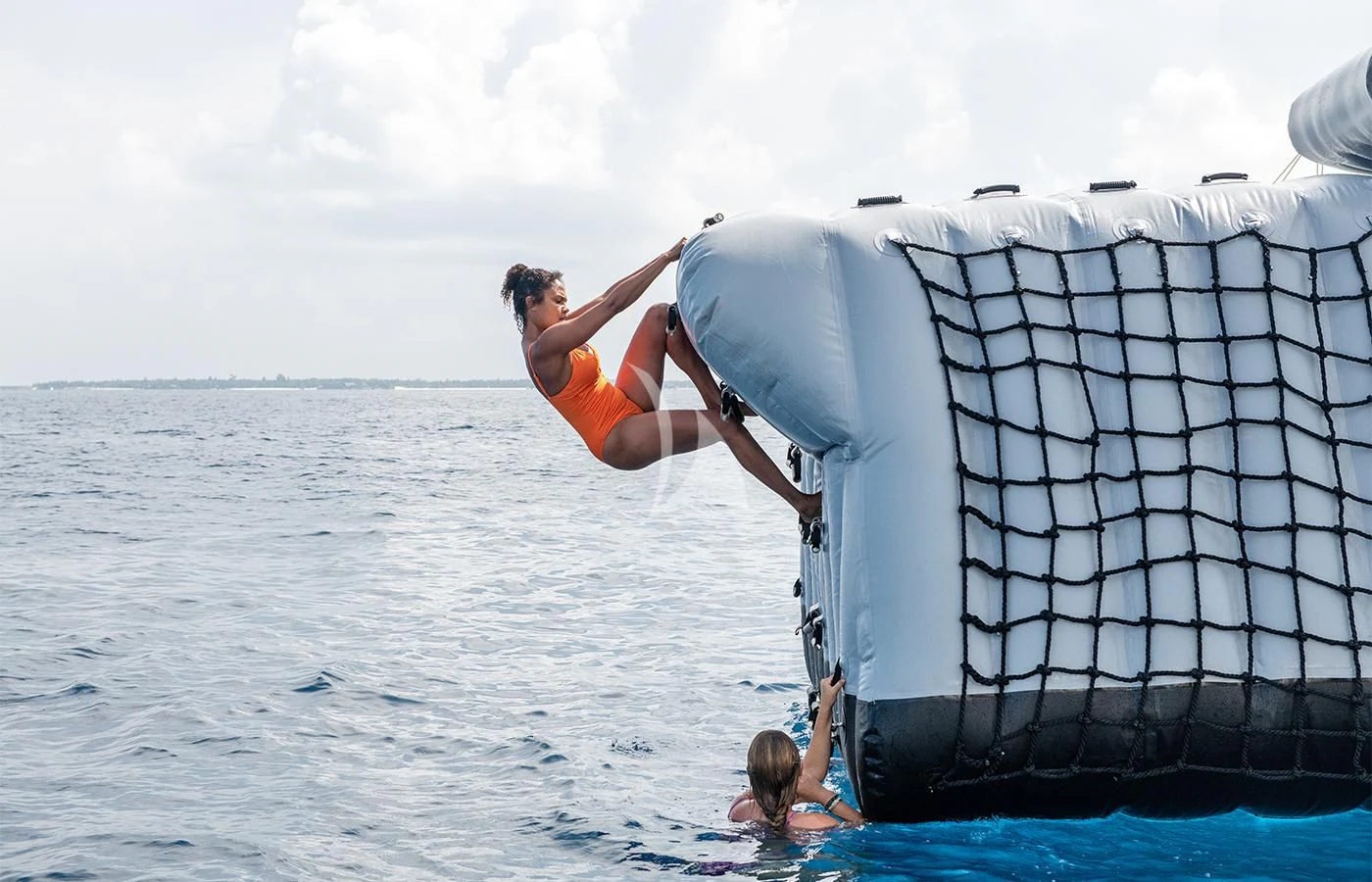 a man from a net into the water aboard JAGUAR Yacht for Charter