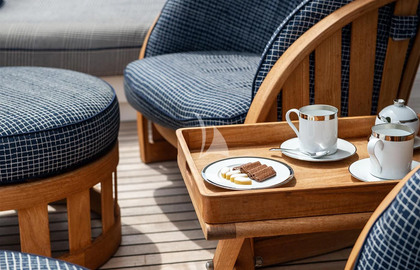 a coffee table with a plate of cookies and a mug on it aboard JAGUAR Yacht for Charter