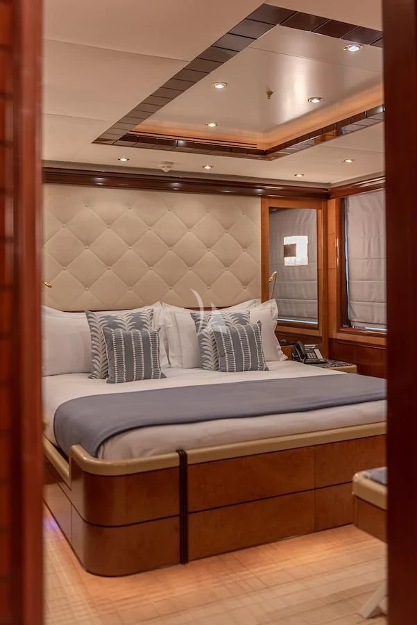 a bed with a wooden frame aboard JAGUAR Yacht for Charter