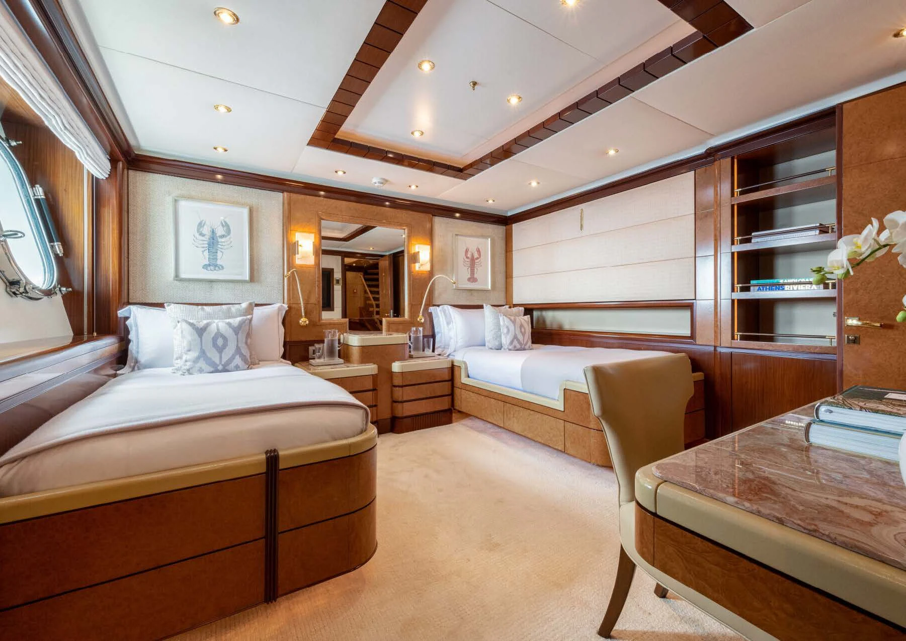 a room with a bed and a table aboard JAGUAR Yacht for Charter