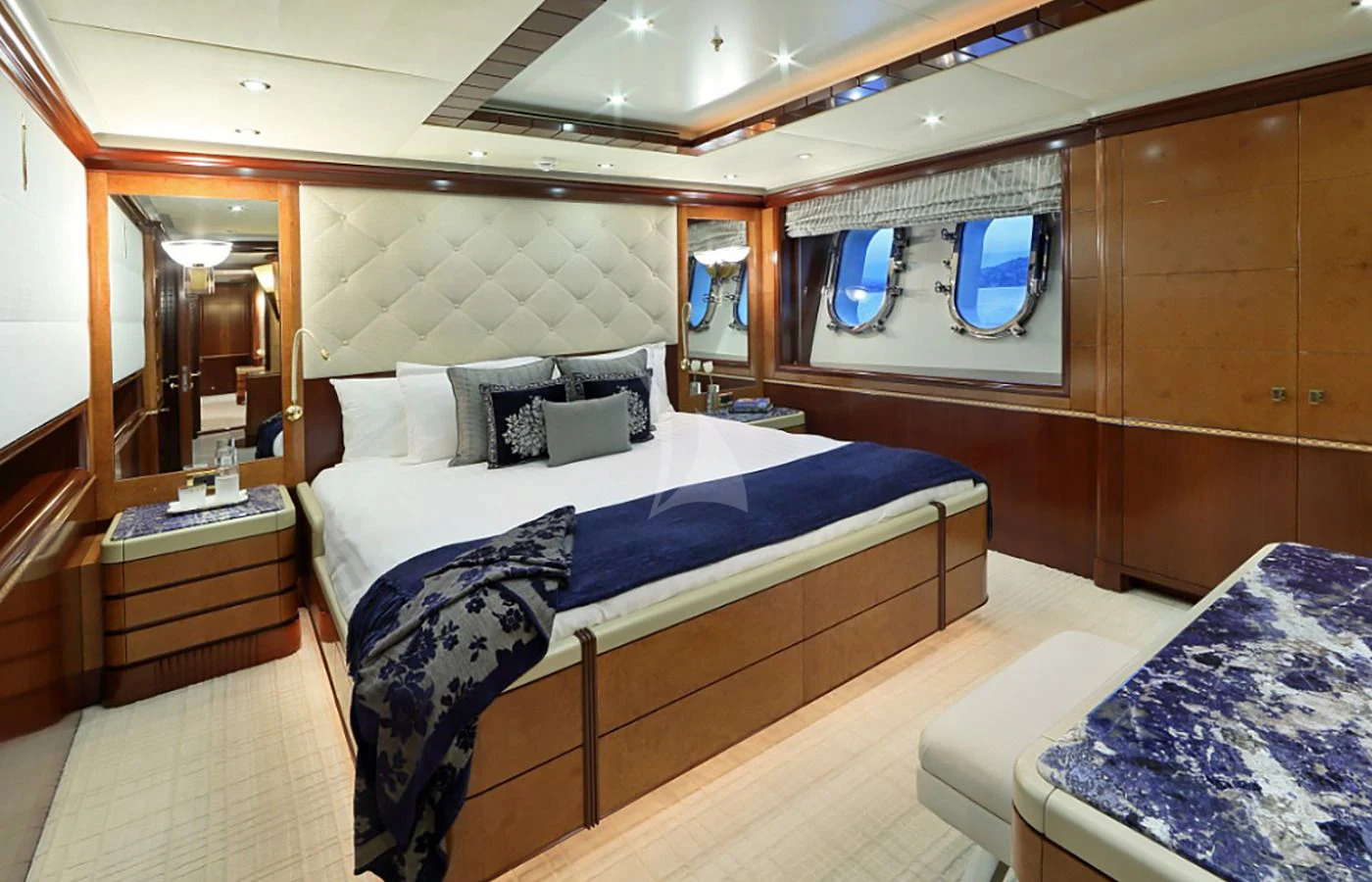 a room with a bed and a mirror aboard JAGUAR Yacht for Charter