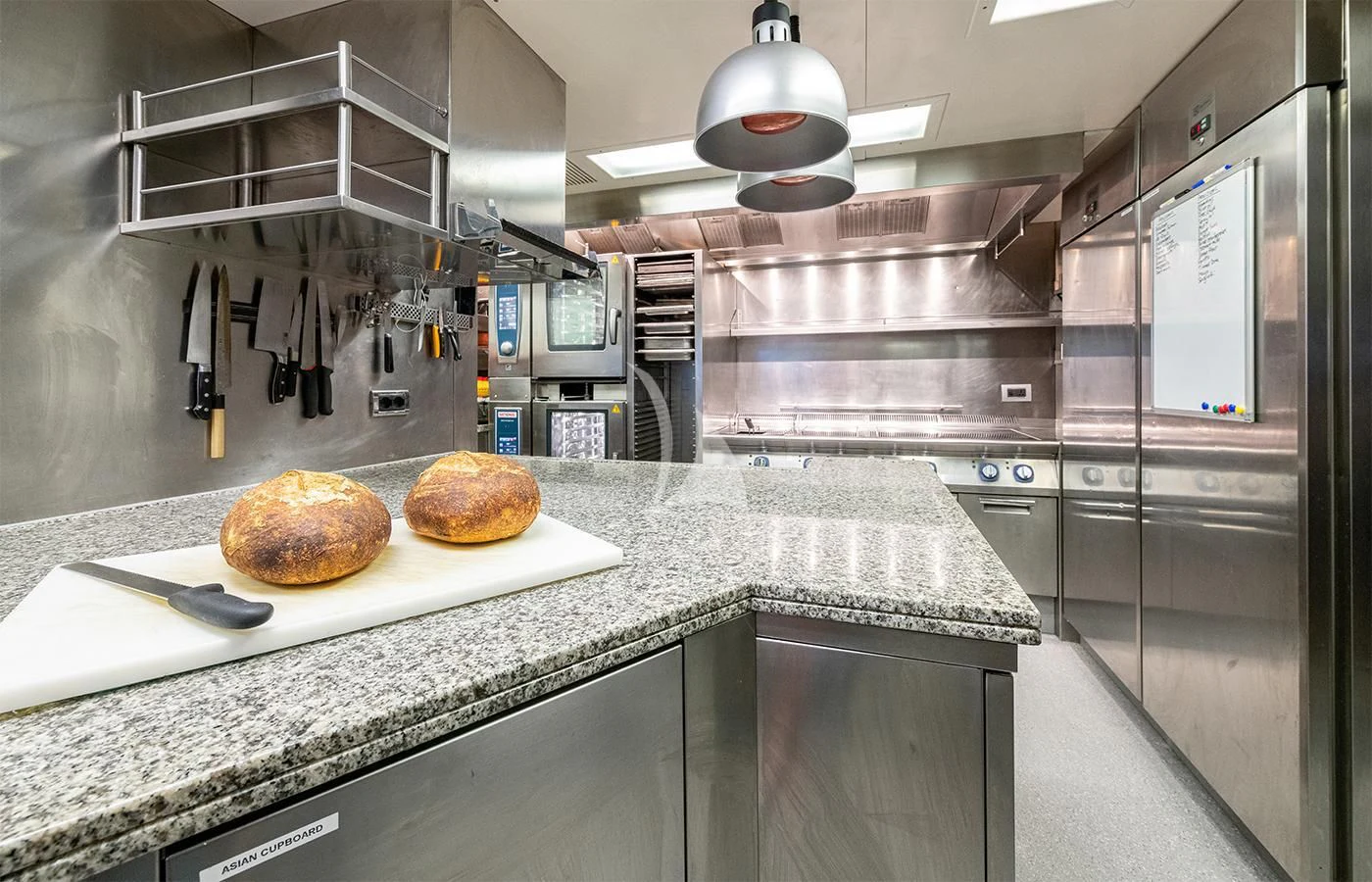 a couple of pizzas sit on a counter top aboard JAGUAR Yacht for Charter