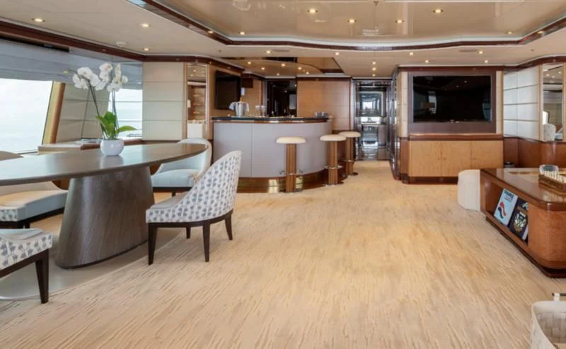 a large room with tables and chairs aboard JAGUAR Yacht for Charter