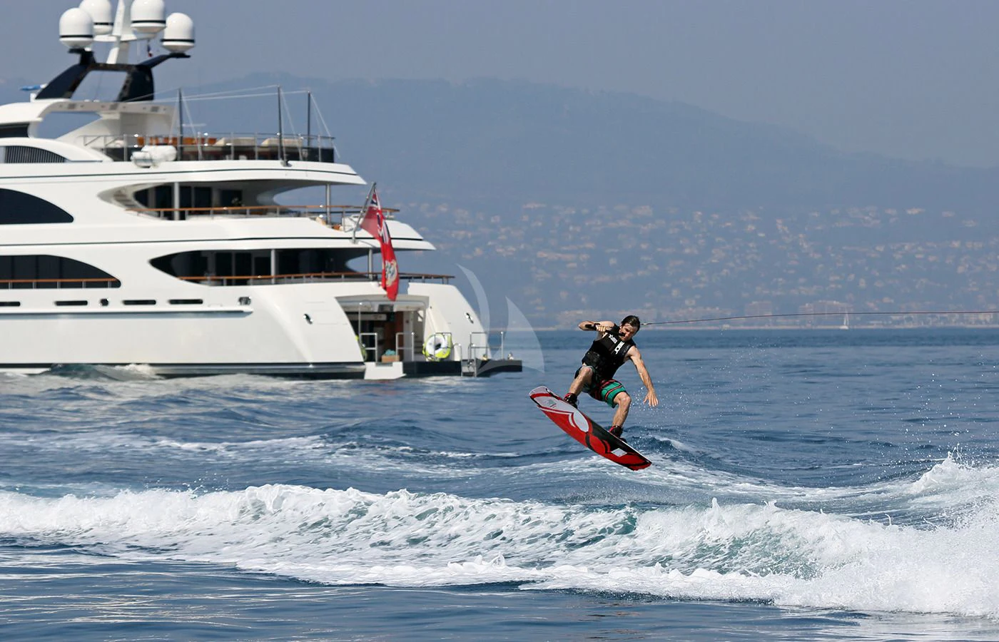a man surfing in the sea aboard JAGUAR Yacht for Charter