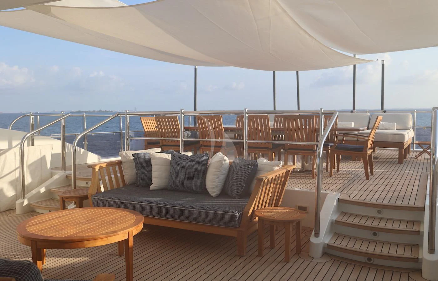 a large living room with a large balcony overlooking the ocean aboard JAGUAR Yacht for Charter