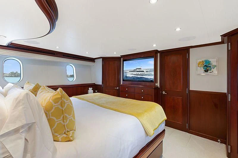 a bedroom with a bed and a television aboard LEMONADE Yacht for Sale