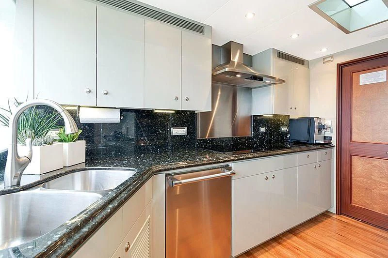a kitchen with a stove and a sink aboard LEMONADE Yacht for Sale