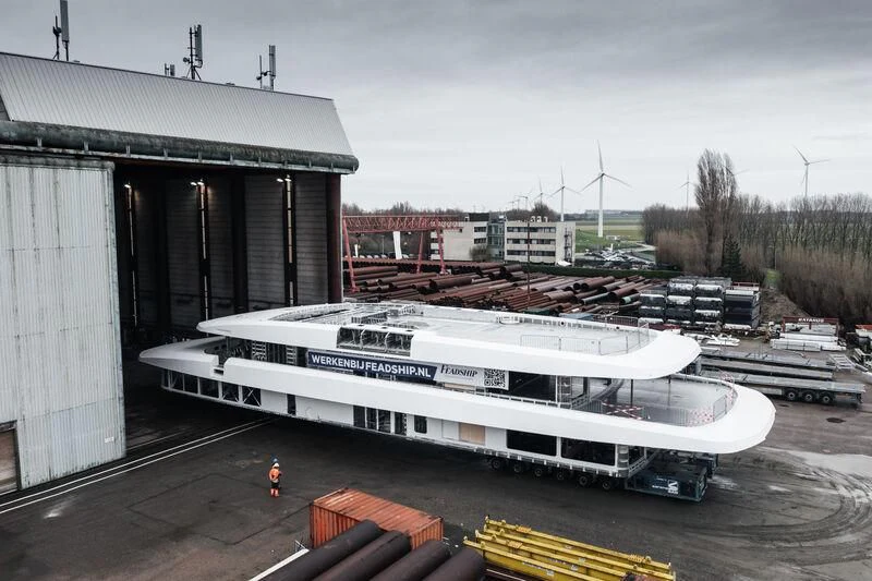 a large white boat in a dock aboard DRIZZLE Yacht for Sale