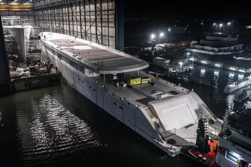 a large white ship docked at a pier at night aboard DRIZZLE Yacht for Sale