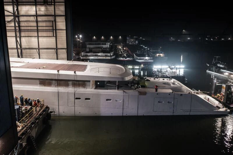 a large ship docked at night aboard DRIZZLE Yacht for Sale