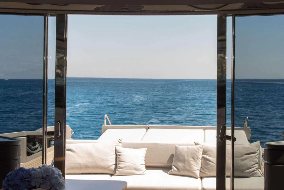 a bed and a window overlooking the ocean aboard W Yacht for Sale