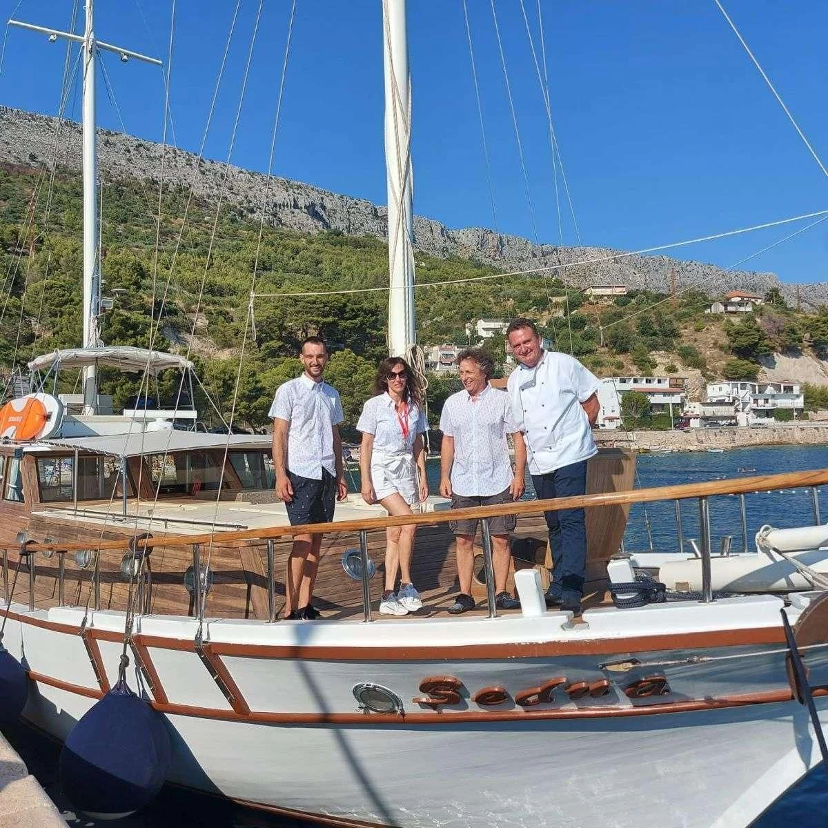 a group of people standing on a boat aboard W Yacht for Sale